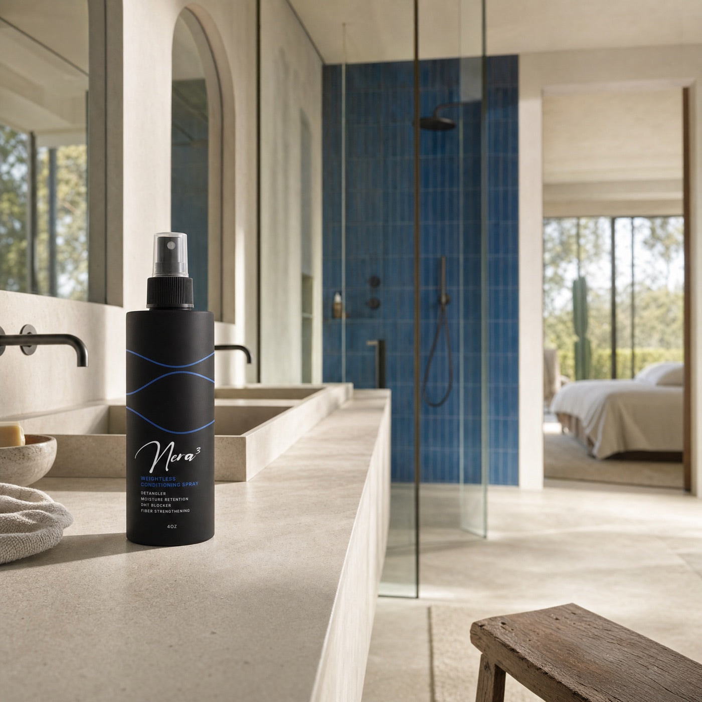 The Nera3 Weightless Conditioning Spray on a stone vanity beside a blue-tiled shower